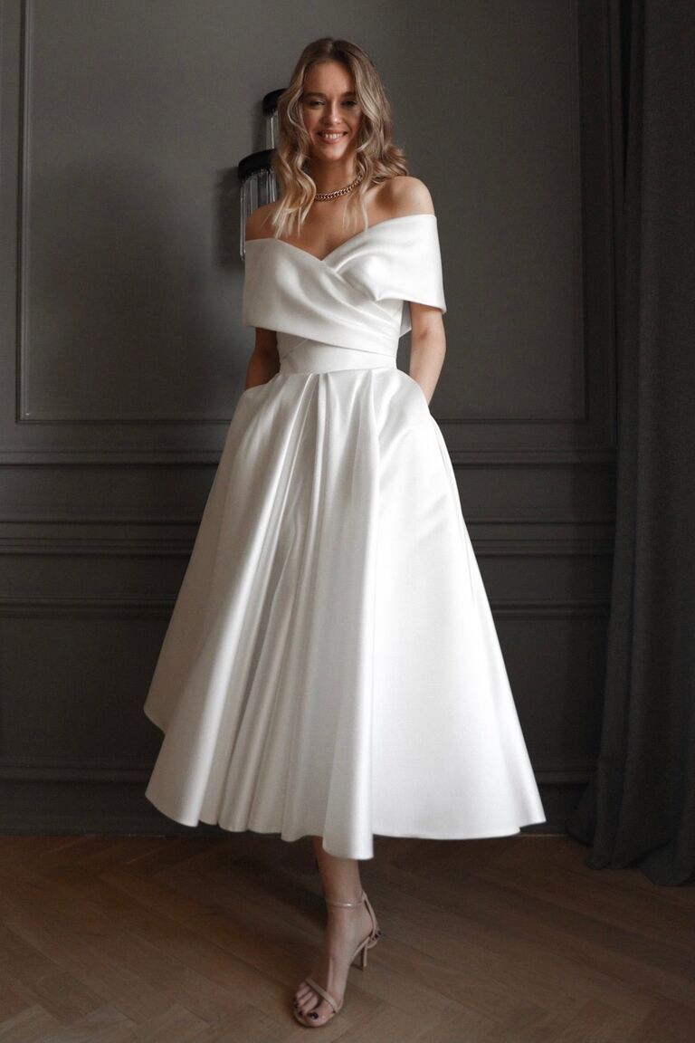 Off the shoulder petite wedding dress by Olivia Bottega. 