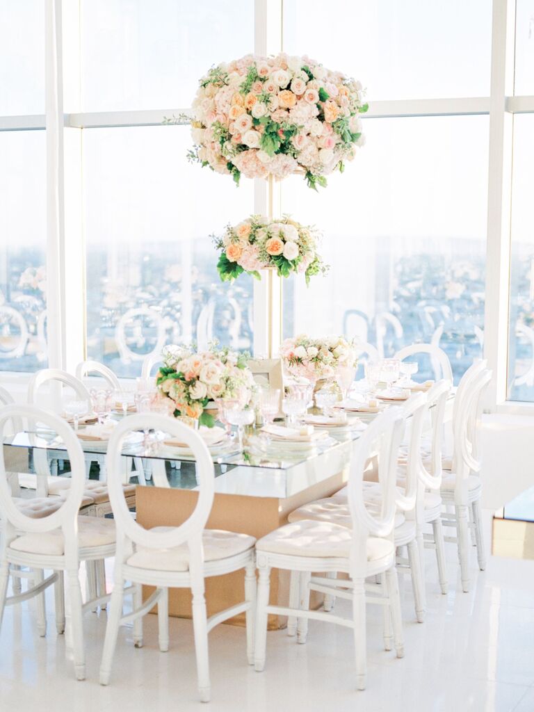 luxe two-tier wedding centerpiece with pink roses and gold pedestal
