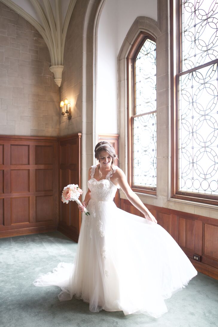 Kara's dress was elegant and flowing, allowing her to stay comfortable for her summer wedding. It had a fitted lace bodice with a sweetheart neckline and lace straps, with lace appliques and embellishments down the skirt, which she accented by wearing crystal earrings and a sparkly headband.