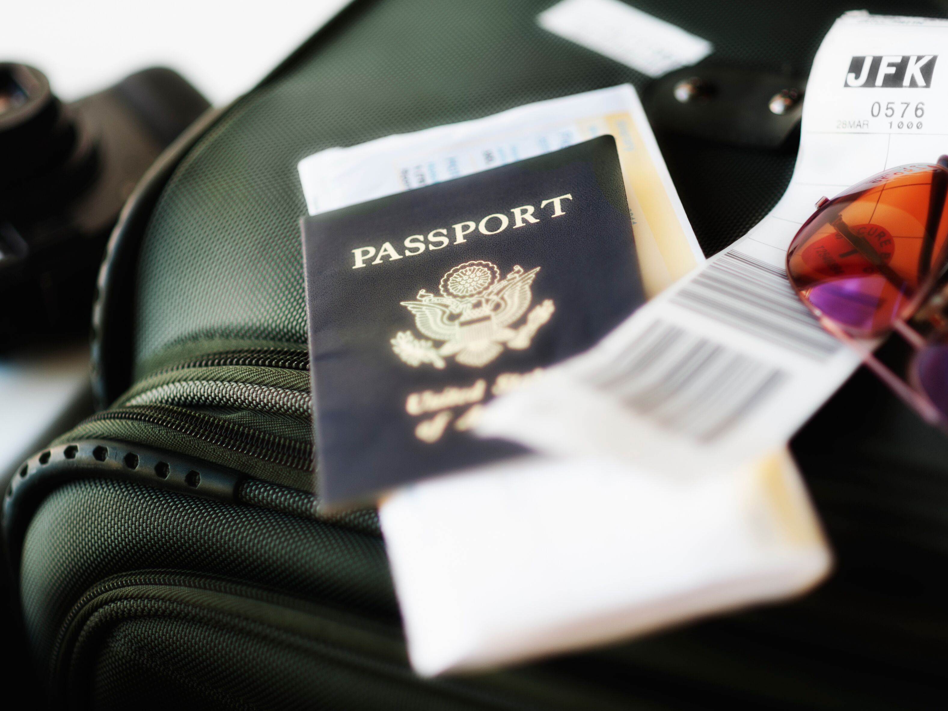 passport with luggage packed for travel 