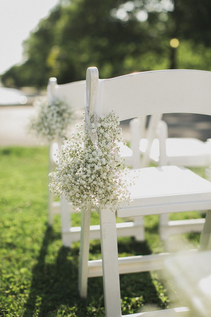 The chairs on the ceremony aisle were decorated with small bouquets of baby's breath.