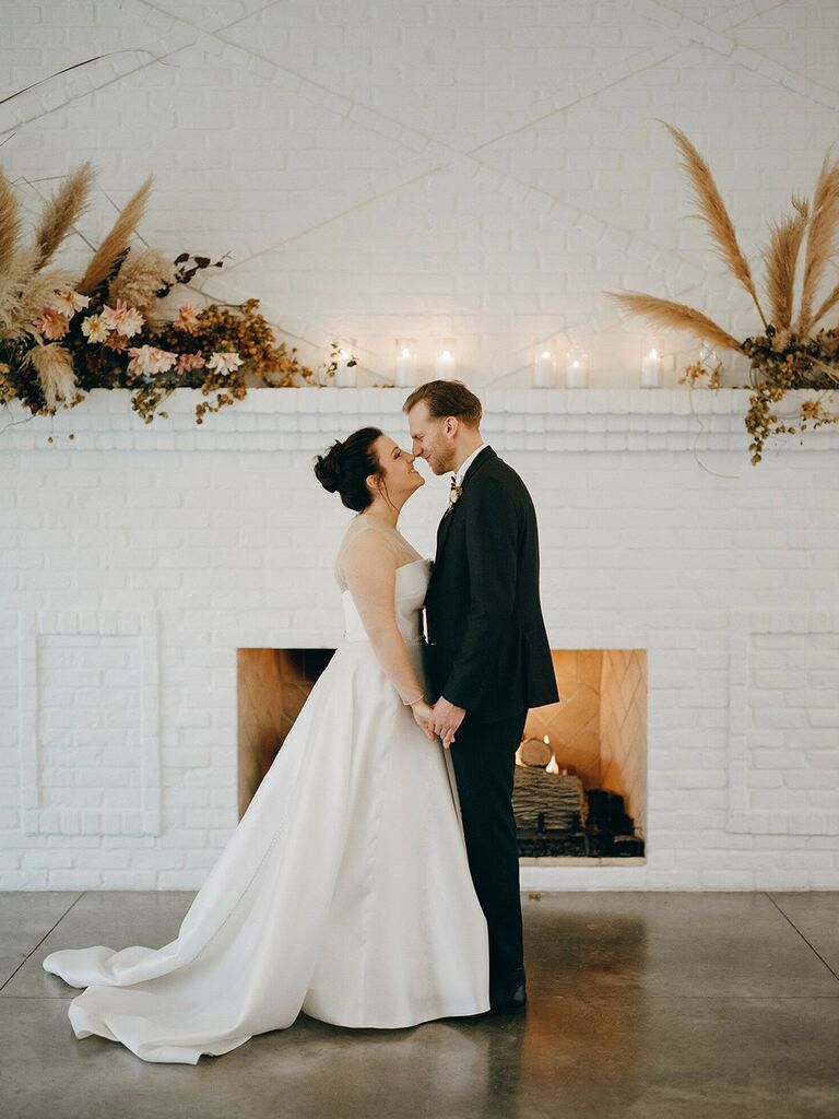 Bride and groom touching noses smiling