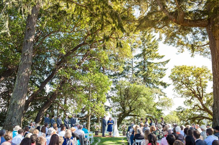 "Our families were split geographically on opposite sides of the country, so we were looking at a 'destination' wedding no matter where we chose. We both wanted nature to be a prominent feature of our wedding, so we decided to host all the festivities at the cattle and timber ranch where Tyler grew up," says Allyson. "The ranch is nestled on a ridge above the Sonoma coastline with giant redwoods, fields with cows, and not a single restaurant or store to be found for miles. It was important to us both that our wedding be unique to us. So we built our venue completely from scratch. We planted grass, watered, and even fenced out wild pigs, to create a small oasis under the trees for our ceremony. We built a stage from redwood harvested on the ranch, made signs and tables from old fence posts, and used hay bales from the barn just up the road. We tried hard to use as many resources from the ranch as possible, to honor the special location."