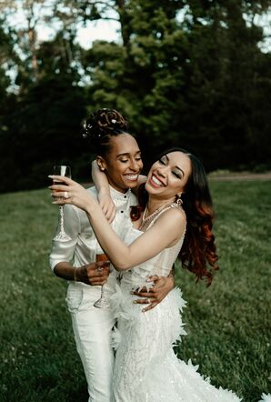 Couple Hugging and Smiling With Champagne Flutes