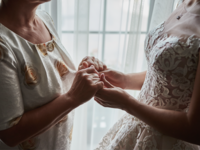 mother and daughter holding hands on wedding day