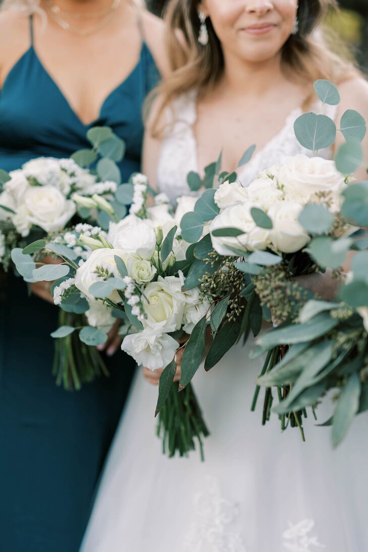 Bride and Bridesmaids Holding Bouquets of Eucalyptus and Greenery With White Flowers