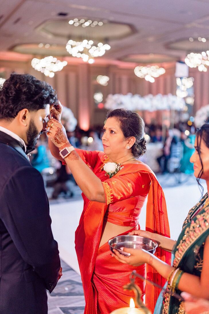 Mother of the Groom Welcome Blessing Making Sign of Cross on Newlyweds' Foreheads, Indian Wedding