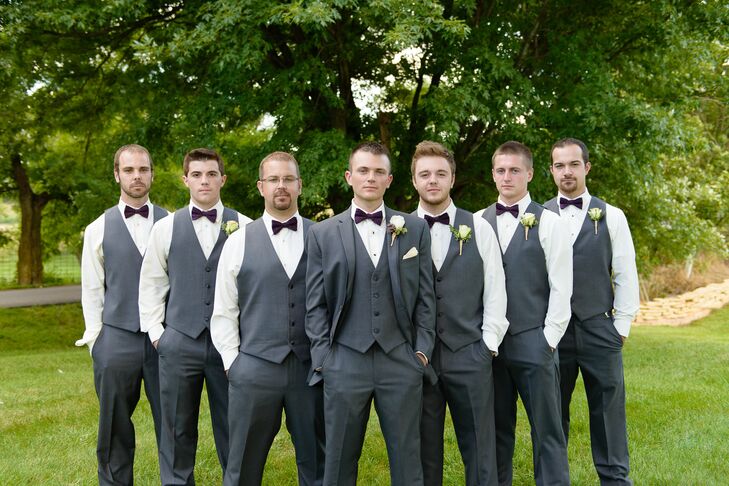 Groomsmen in Dark Grey Tuxedos with Plum Bow Ties and Ivory Rose Boutonnieres