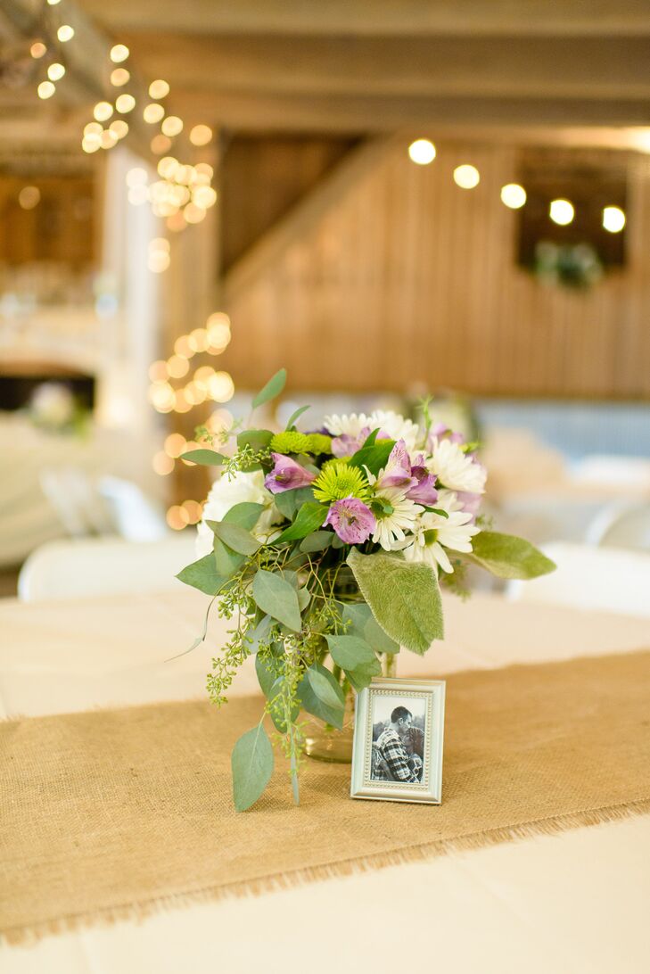 Mark and Amanda dressed their reception tables in ivory table cloths with burlap runners. Each table had a mason jar centerpiece with a photo of them.