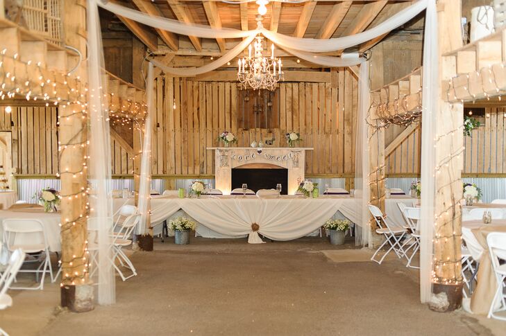 The rustic barn at Coffee Creek Ridge was decorated with white string lights, chandeliers and antique items for the reception.