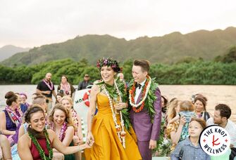 Newlywed couple on boat at wedding with guests