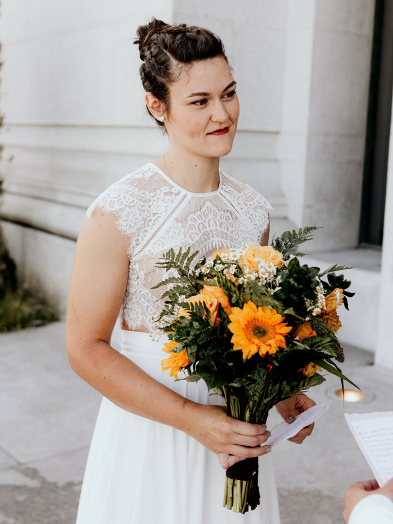 To-be-wed holding bouquet with yellow Gerbera daisies