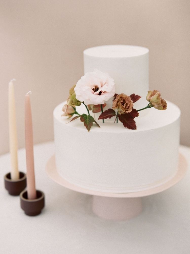 simple two-tier spring wedding cake with fresh flowers