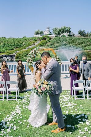 Couple Sharing Kiss During Wedding at Leal Vineyards in Hollister,  California