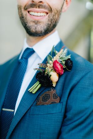 Blue Suit with Patterned Accessories and Bright Boutonniere