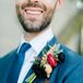 Blue Suit with Patterned Accessories and Bright Boutonniere