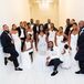 White Bridesmaid Dresses and Groomsmen in Black Tuxedos