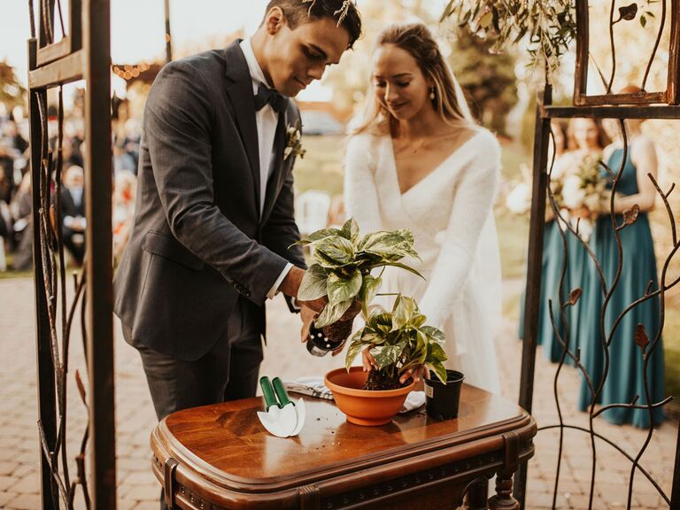 Bride and groom planting succulent during wedding unity ceremony