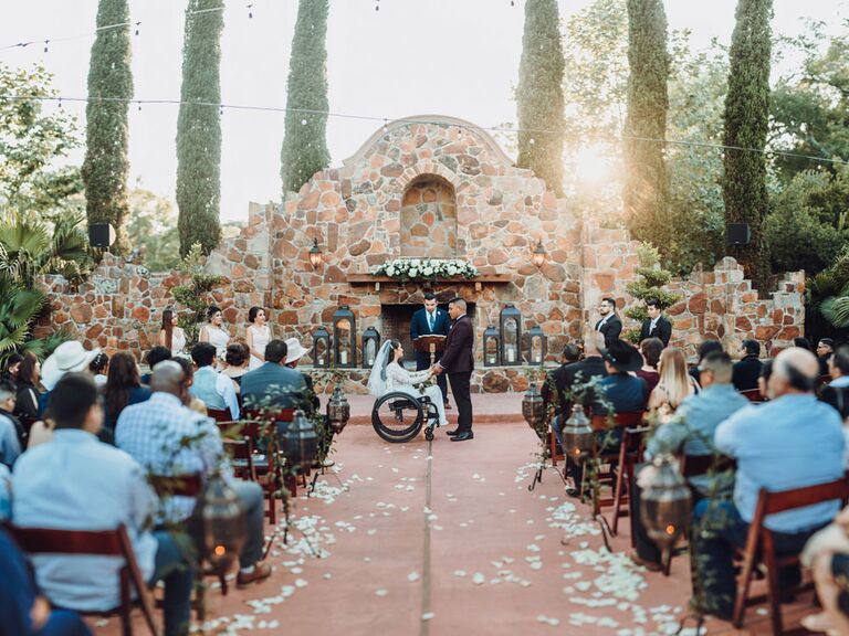Bride and groom saying vows during outdoor wedding ceremony