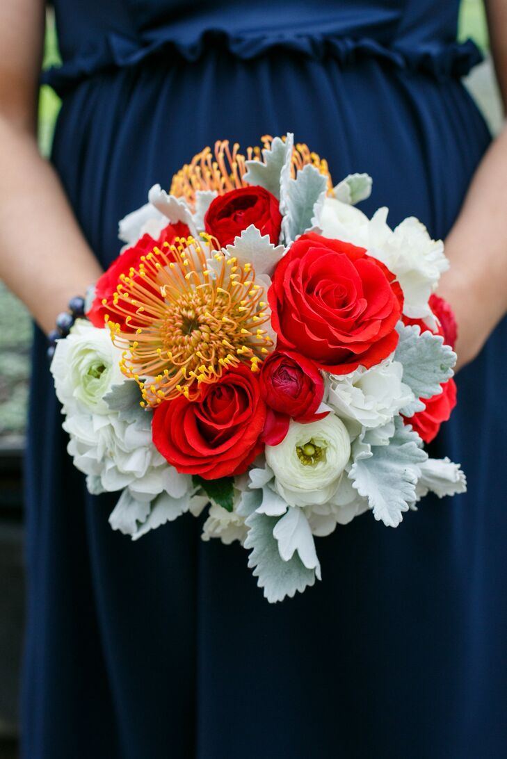 Red roses and white ranunculuses and peonies completed the Americana bridesmaid look.
