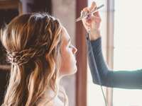 Woman getting airbrush makeup applied