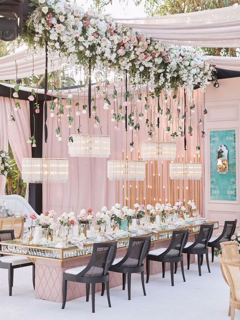 glam hanging flowers wedding with pink and white roses, and crystal chandeliers on black ribbons hanging from ceiling