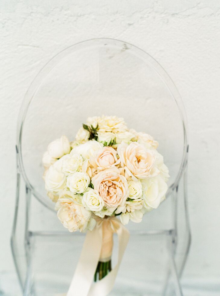 For their flowers, Mia and Jake kept things simple, opting for classic arrangements of hydrangeas, carnations and roses. For the bridal bouquet, Celadon and Celery Events created a romantic bundle of ivory and blush roses, which they accented with blush satin ribbon for a refined, ladylike finish.