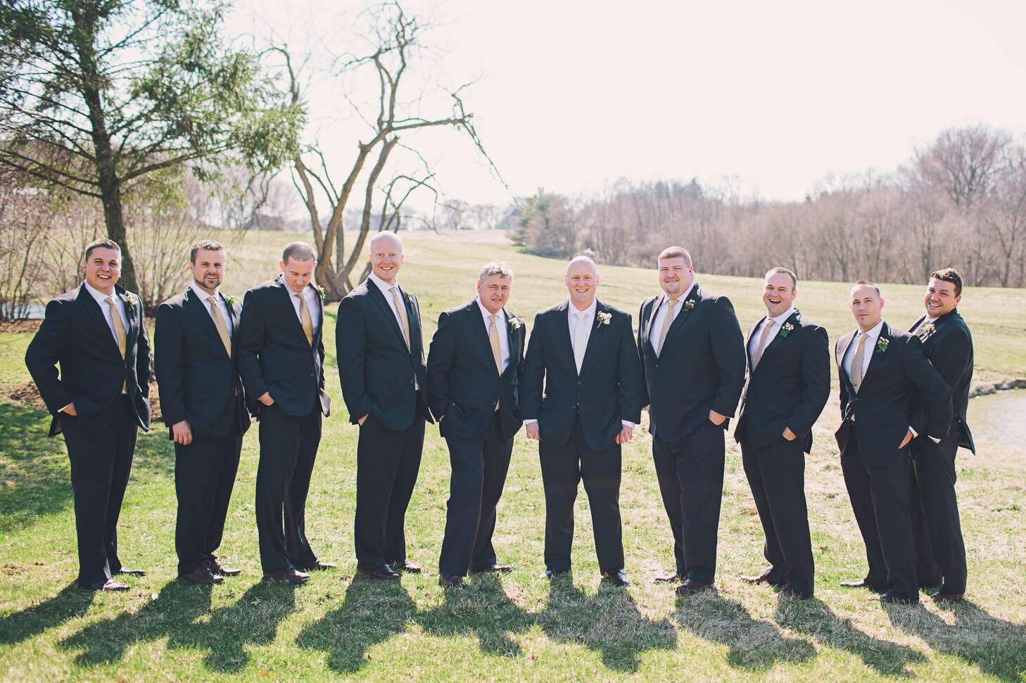 Groomsmen In Black Suits And Gold Ties