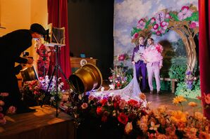 Grooms in Bold Outfits Posing Together on Stage at Custom, Whimsical Photo Booth, Theater