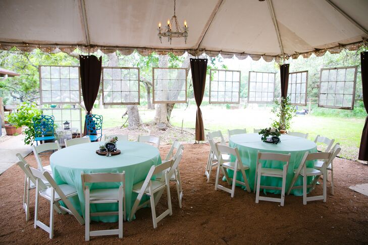 The reception took place under an open-air tent. Mint tablecloths brought playfulness and whimsy to the reception decor, while suspended vintage mirrors and a antique vases delivered charming, old-world flair.