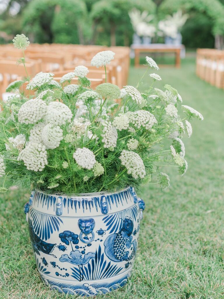 blue chinoiserie vase filled with queen anne's lace flowers