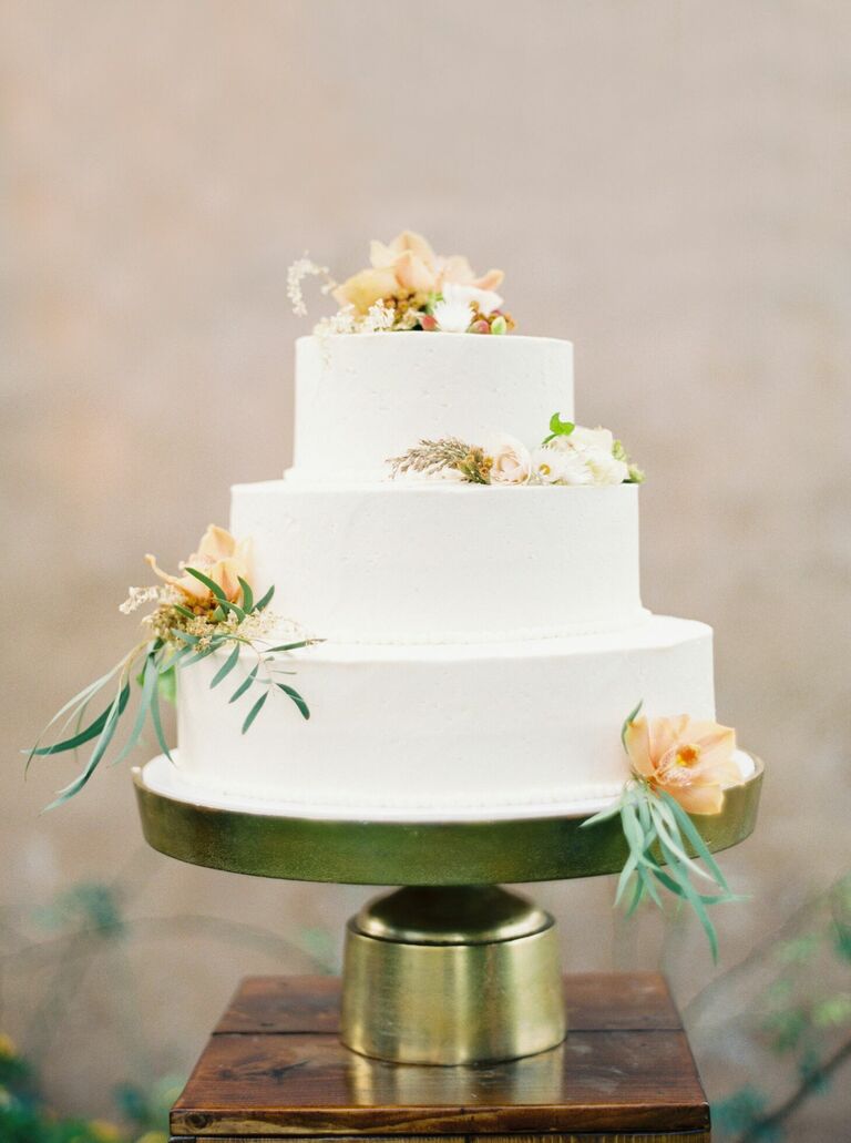 Modern three-tier cake sitting on gold cake stand