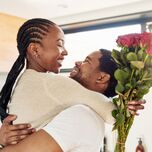 Husband and wife embracing after gifting her flowers