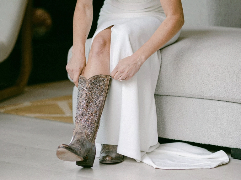 Bride putting on glitter cowboy boots. 