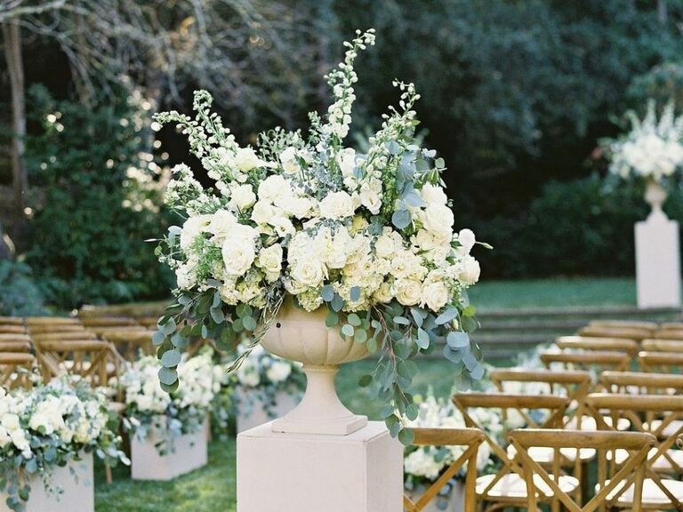 wedding ceremony aisle floral arrangement with stock and eucalyptus