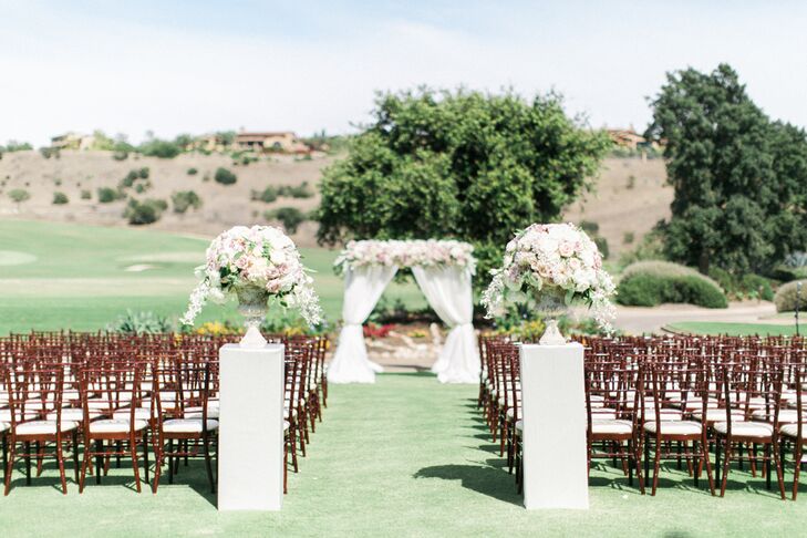 "Our vision for the wedding was a romantic garden style. We wanted to create an atmosphere where our family and friends could feel special but also welcome and comfortable," Bree says. At their outdoor ceremony, Bree and Greg exchanged vows under a decadent, rose-garland-topped arch as their guests looked out onto the country club’s manicured grounds.