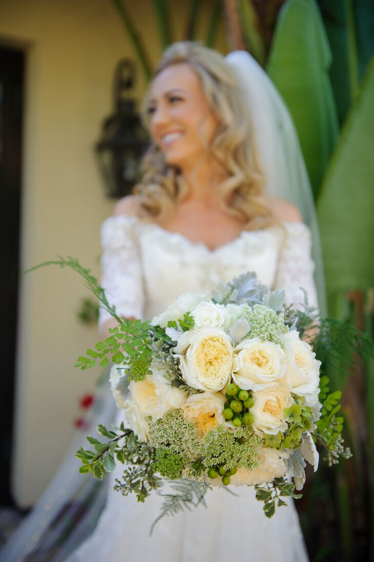 Jill held a bouquet filled with yellow and white roses accented with hypericum berries, Queen Anne's lace and other greens.