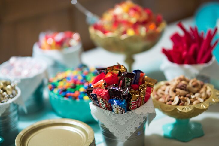 Both Melissa and Dustin admit to having a serious sweet tooth, so incorporating a candy bar into the reception was an obvious choice. The couple stocked a table with their favorite sweet treats, including mini chocolate bars, nuts, Twizzlers, Skittles and mini cupcakes, for their guests to enjoy after dinner.