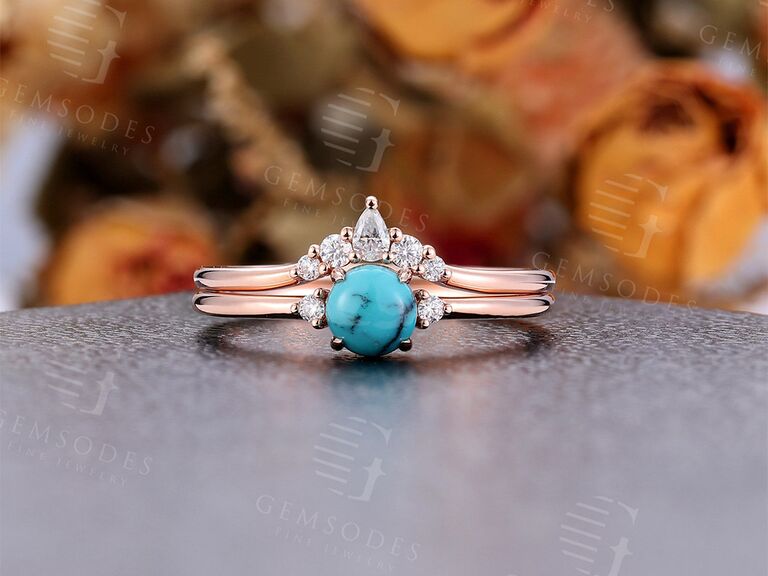 Round turquoise center stone surrounded by diamonds on rose gold double band