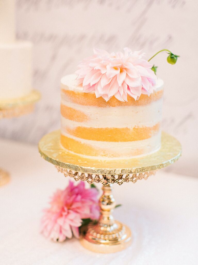 one tier wedding cake with semi-naked frosting and pink cafe au lait dahlia on gold cake stand