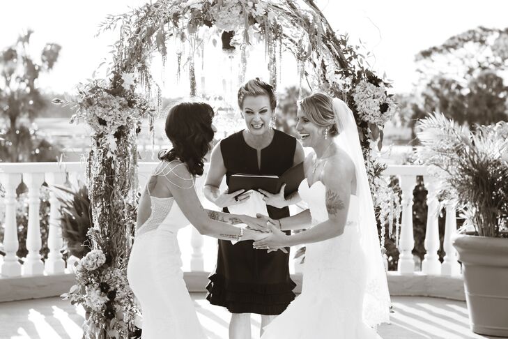 “Our ceremony was my favorite,” Cassandra says. “It was outside overlooking a golf course with a beautiful fountain.” The brides exchanged vows in front of an altar covered in flowers with a chandelier hung from above.
