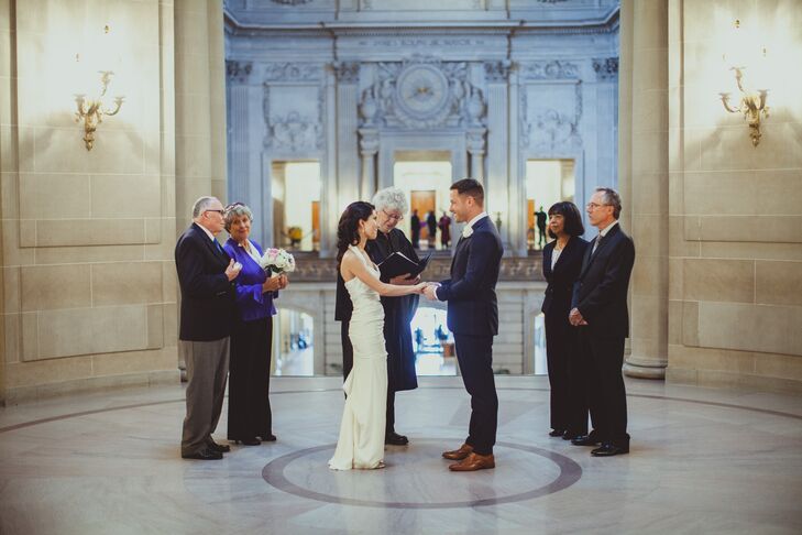 Jennifer and Matt join hands in matrimony with parents by their side at their wedding ceremony at San Francisco City Hall.
