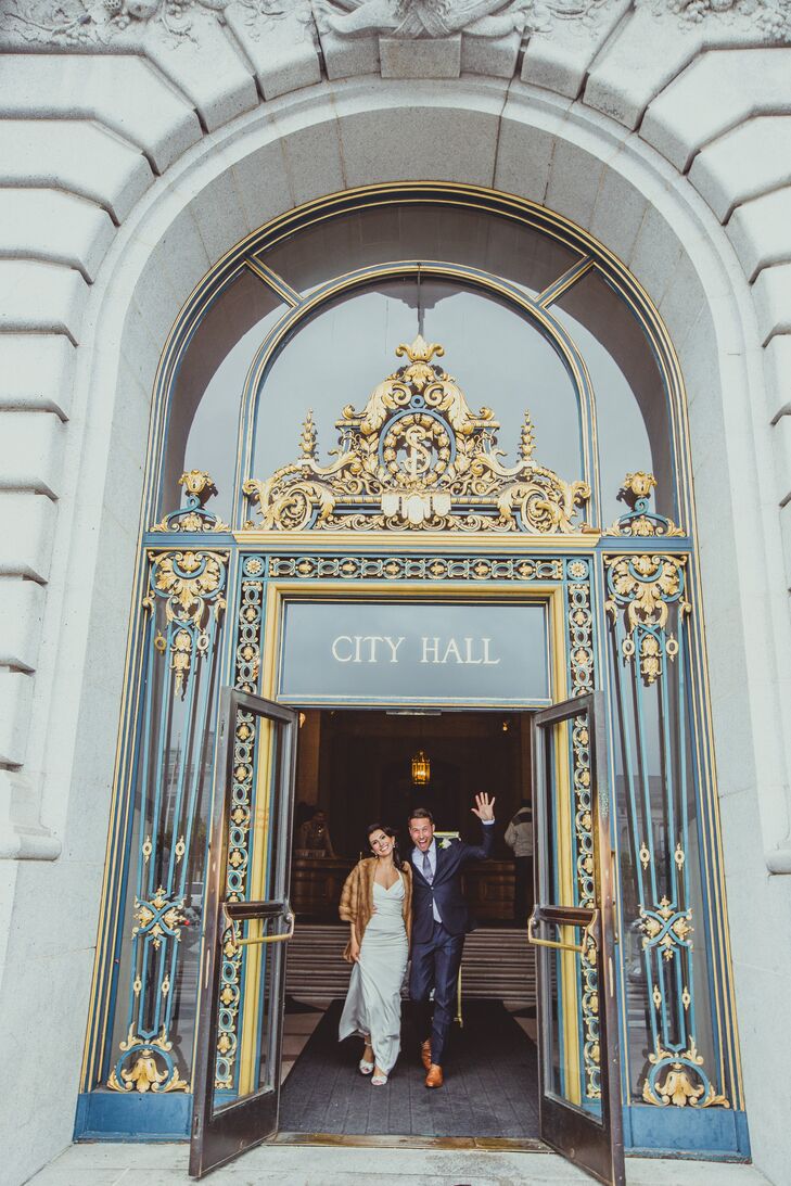 The bride and groom exited their ceremony as a married couple through the golden doors of San Francisco City Hall.