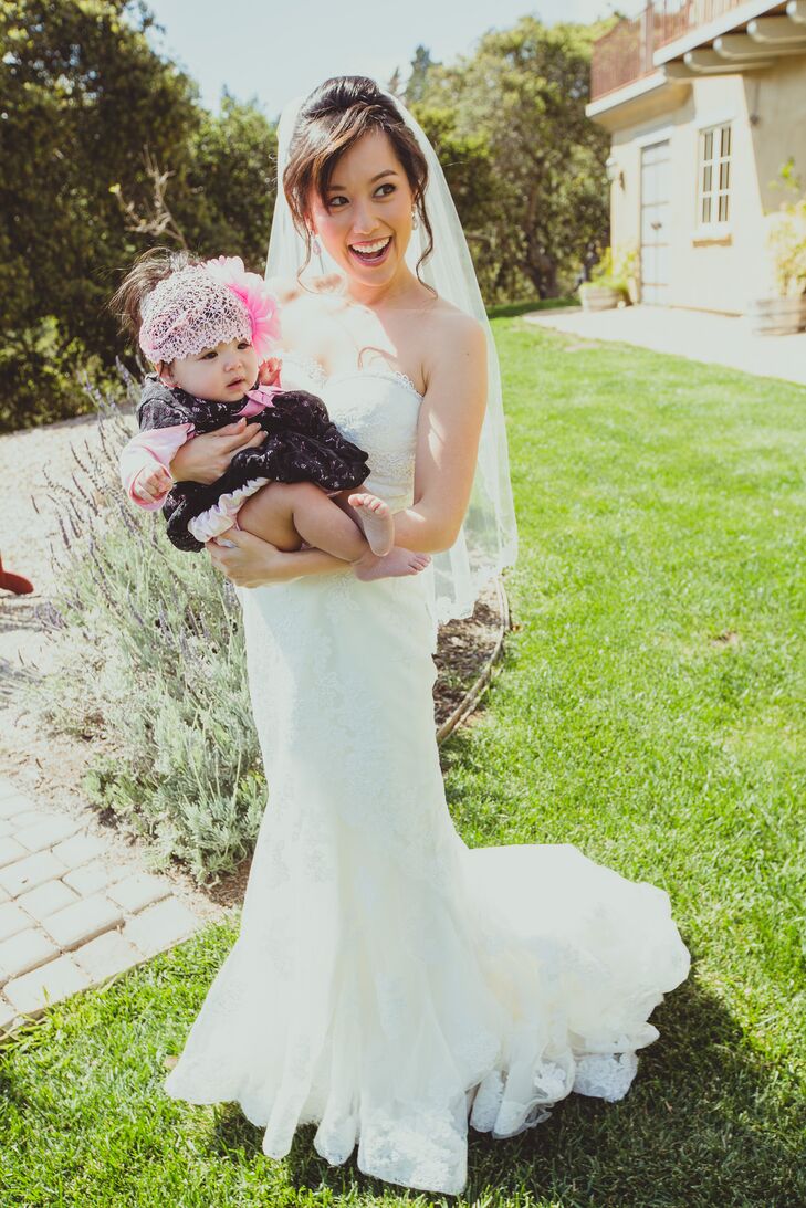 Bride in Wedding Dress Cradling Baby