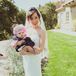 Bride in Wedding Dress Cradling Baby