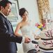 The bride and groom cut their ivory wedding cake decorated with a tree design that had pink flowers.