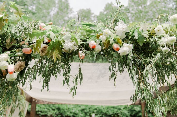 Sarah and Paul's custom chuppah included a special nod to their Jewish culture: the seven species of food--wheat, barley, grapes, figs, pomegranates, olives and date honey--were intertwined throughout the weeping greenery.