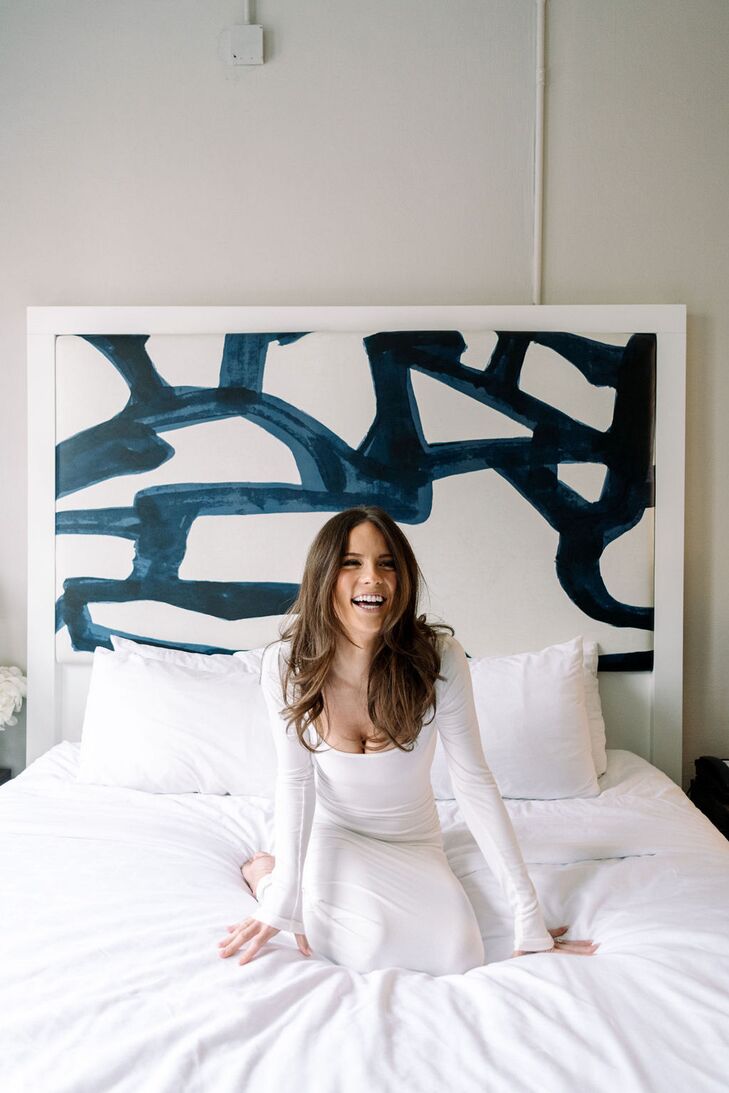 Bride in Fitted Dress, Natural Makeup and Down Hairstyle on Hotel Bed