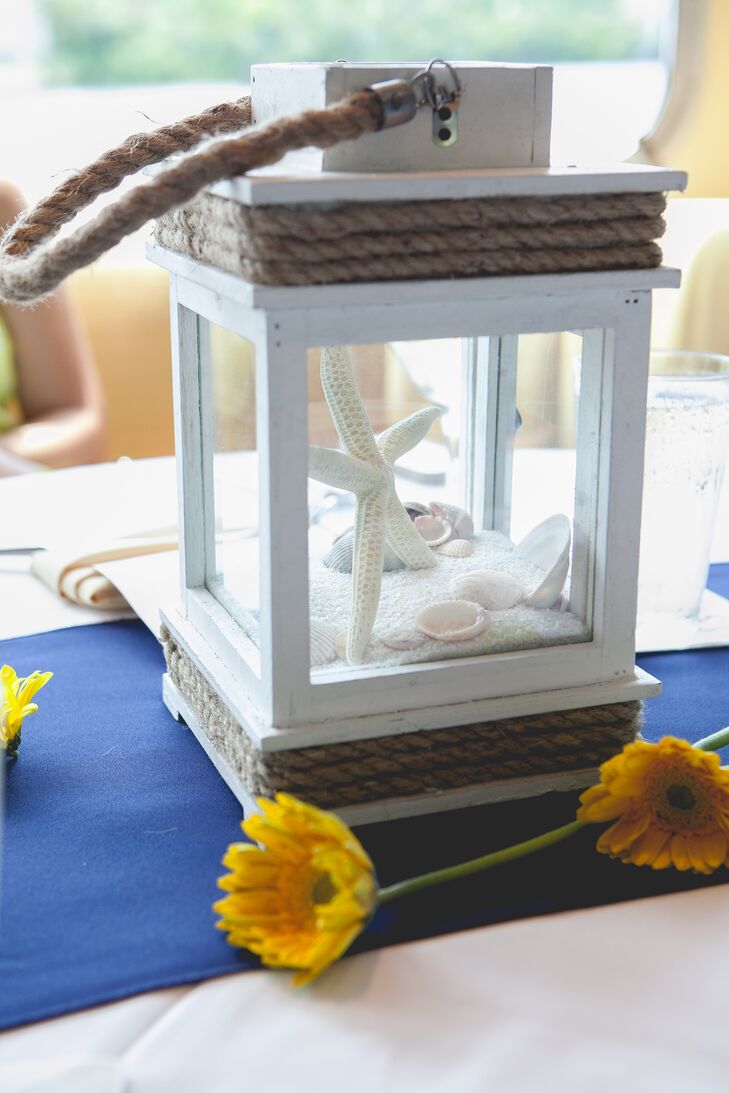 Becky and Rob accented their nautical theme with wooden blue and white sailboats, lanterns filled with seashells and yellow chrysanthemums in netted blue glass bottles.