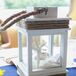 Becky and Rob accented their nautical theme with wooden blue and white sailboats, lanterns filled with seashells and yellow chrysanthemums in netted blue glass bottles.